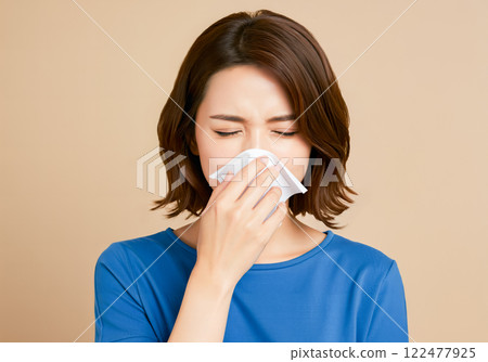 A woman suffering from allergic rhinitis 122477925