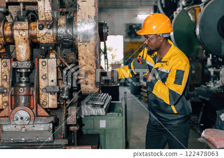 professional black african engineer team inspecting service machine in heavy industry factory 122478063