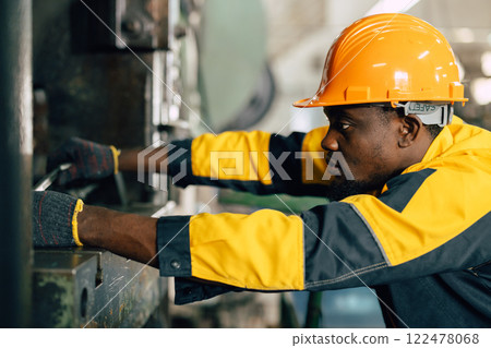 professional black african engineer team inspecting service machine in heavy industry factory 122478068