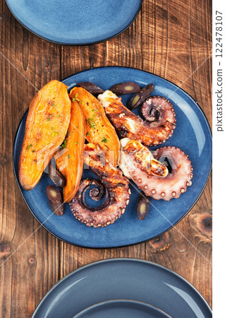 Grilled octopus with potato. 122478107