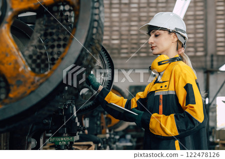 professional engineer caucasian women inspecting auditing old machine in heavy industry factory professional engineer caucasian women inspecting auditing old machine in heavy industry factory 122478126