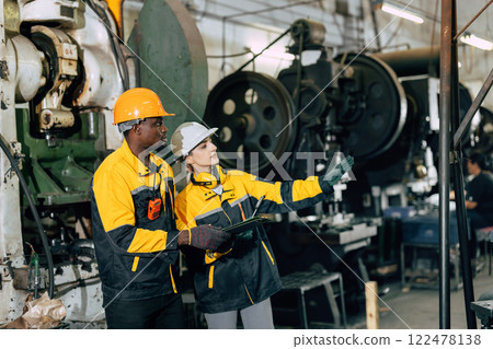 professional engineer team inspecting service machine in heavy industry factory professional engineer team inspecting service machine in heavy industry factory 122478138