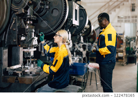 caucasian women worker working in heavy metal industry factory punching stamping steel machine 122478165