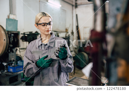 professional caucasian engineer women inspector check product quality in metal factory industry professional caucasian engineer women inspector check product quality in metal factory industry 122478180