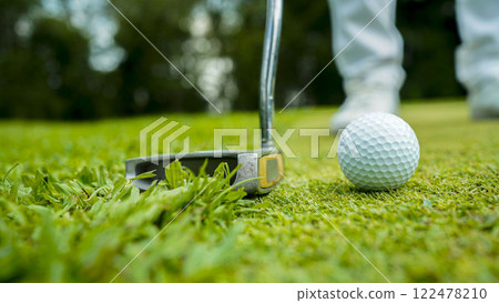 golfer playing golf in the evening golf course, on sun set evening time. 122478210