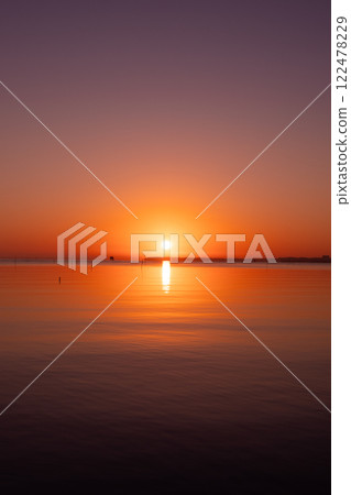 The sun rising over the lake, a bright red sunrise 122478229