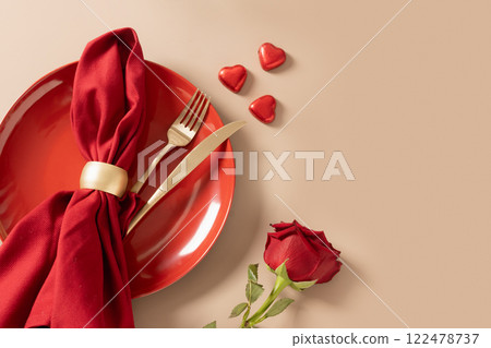 Valentine's day romantic table setting with red plate and red roses on beige background. View from above. Copy space. Festive dinner. Valentine's day romantic table setting with red plate and red roses on beige background. View from above. Copy space. Festive dinner. 122478737