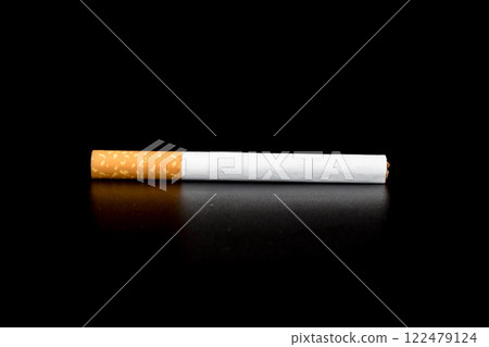 Cigarette butts isolated on black background Cigarette butts isolated on black background 122479124