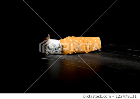 Cigarette butts isolated on black background Cigarette butts isolated on black background 122479131