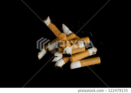 Cigarette butts isolated on black background 122479135