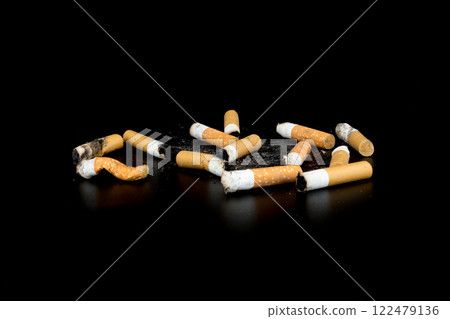 Cigarette butts isolated on black background 122479136