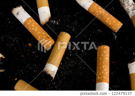 Cigarette butts isolated on black background 122479137