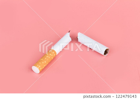 Cigarette butts isolated on pink background Cigarette butts isolated on pink background 122479143