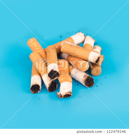 Cigarette butts isolated on blue background Cigarette butts isolated on blue background 122479146