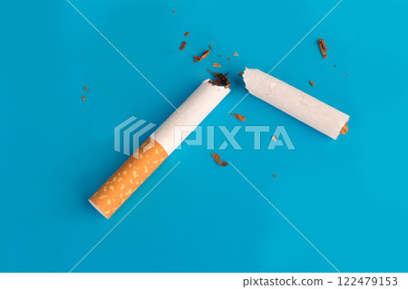 Cigarette butts isolated on blue background Cigarette butts isolated on blue background 122479153
