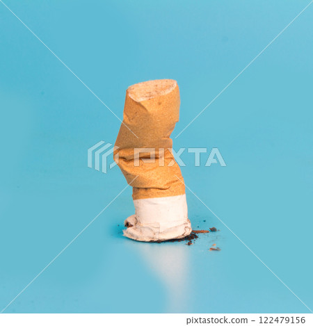 Cigarette butts isolated on blue background 122479156