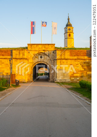 The Clock Tower and Clock Gate stand majestically at Kalemegdan Fortress as the sun sets, casting a warm glow on the historic architecture in Belgrade, Serbia. 122479351