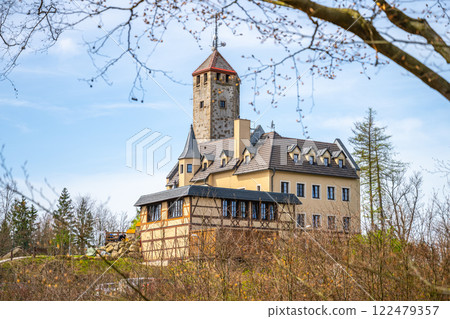 The Liberecka Vysina Lookout Tower stands tall against a clear sky in Liberec, Czechia. Its unique architecture blends with the surrounding nature, inviting visitors to explore. 122479357
