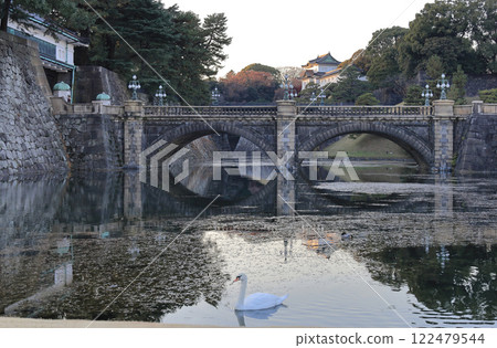 The Imperial Palace at dusk. Swan and the main gate stone bridge, Nijubashi Bridge, and Fushimi Turret The Imperial Palace at dusk. Swan and the main gate stone bridge, Nijubashi Bridge, and Fushimi Turret 122479544