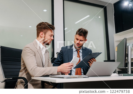 Business team working on a project in the office or reviewing and discussing a business project. 122479738