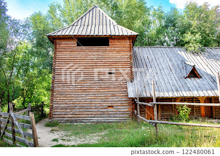 Rustic watchtower wooden structure stands proudly amid lush greenery under a clear sky. 122480061