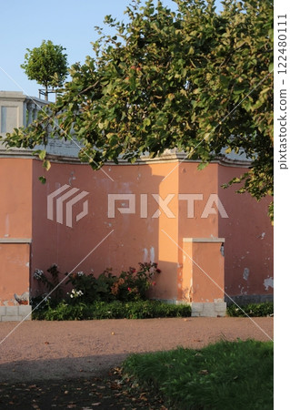 historical architecture vintage plaster in park. wall with cracked red classic style in public park 122480111