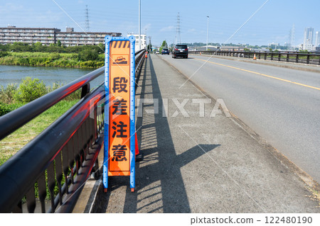 A sign on a bridge warning of steps A sign on a bridge warning of steps 122480190