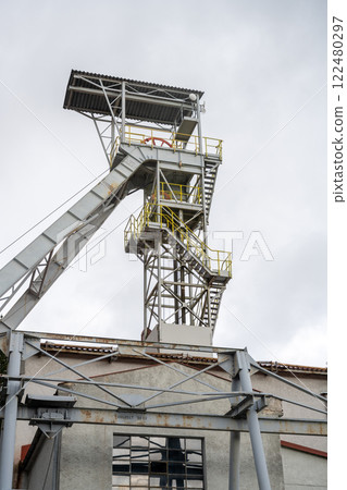 The historic mining tower in Jachymov, Czechia stands against a gray sky. This structure highlights the region's rich mining heritage and industrial architecture. 122480297