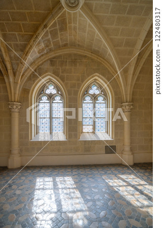 The interior of the Schwarzenberg Tomb features stunning gothic windows that illuminate the space. Intricate stonework and soft light create a serene atmosphere in Domanin, Czechia. 122480317