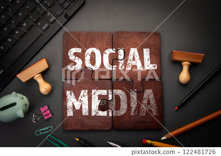 SOCIAL MEDIA. Wooden puzzle pieces with text on a dark office table 122481726