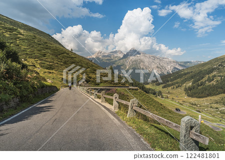 A motorcycle rides on the Spluegen pass road in the Swiss Alps, Canton of Grisons, Switzerland A motorcycle rides on the Spluegen pass road in the Swiss Alps, Canton of Grisons, Switzerland 122481801