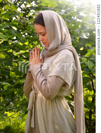 Young girl praying to God Young girl praying to God 122481882