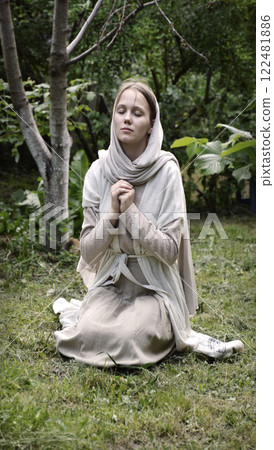 Young girl praying to God Young girl praying to God 122481886