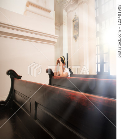 Girl sitting in the church Girl sitting in the church 122481908