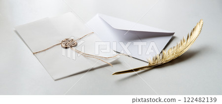 Golden pen and stamped envelope 122482139