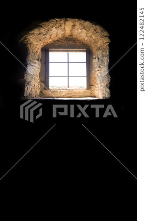 An old window in the dark room 122482145
