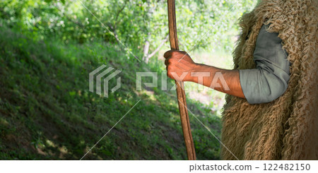 Man's hand with a wooden rod 122482150