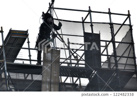 Apartment renovation work: Scaffolding workers dismantling temporary scaffolding Apartment renovation work: Scaffolding workers dismantling temporary scaffolding 122482338