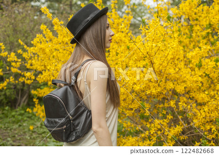 Nice young woman wearing stylish outfit in park on spring day. Fashionable look Nice young woman wearing stylish outfit in park on spring day. Fashionable look 122482668