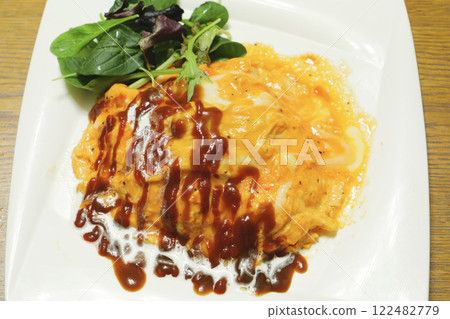 A delicious-looking omelet rice topped with ketchup A delicious-looking omelet rice topped with ketchup 122482779
