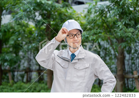 A man in work clothes working at the site A man in work clothes working at the site 122482833