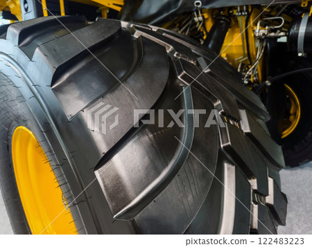 Large agricultural tire showcasing advanced tread design and robust construction for efficient field performance Large agricultural tire showcasing advanced tread design and robust construction for efficient field performance 122483223