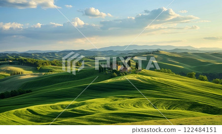 Serene photo capturing rolling green hills and a farmhouse during golden hour 122484151