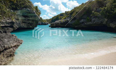 Secluded beach cove with turquoise waters surrounded by rocky cliffs under a clear blue sky Secluded beach cove with turquoise waters surrounded by rocky cliffs under a clear blue sky 122484174