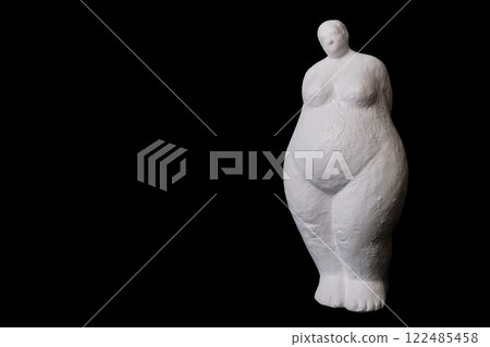 Shy woman of white plaster on black solid background 122485458