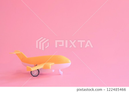 Toy plane on a pink background 122485466