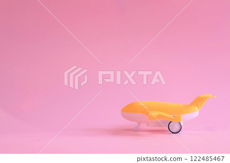 Toy plane on a pink background 122485467