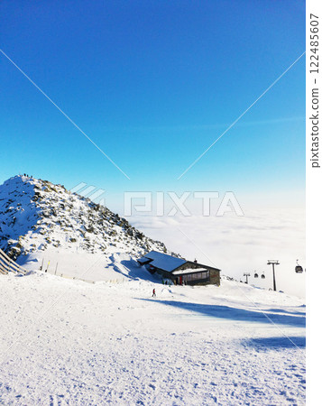 Ski resort. Mountain peak in the clouds Ski resort. Mountain peak in the clouds 122485607