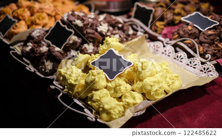 A tray of yellow and brown pastries sits on a table 122485622