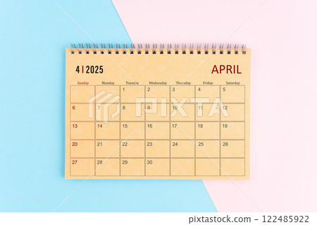 April 2025 craft brown paper calendar on pink and blue background. April 2025 craft brown paper calendar on pink and blue background. 122485922